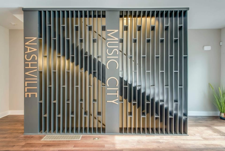 Nashville Music City feature wall on the staircase sets the tone the moment you step inside, a nod to what drew you here in the first place