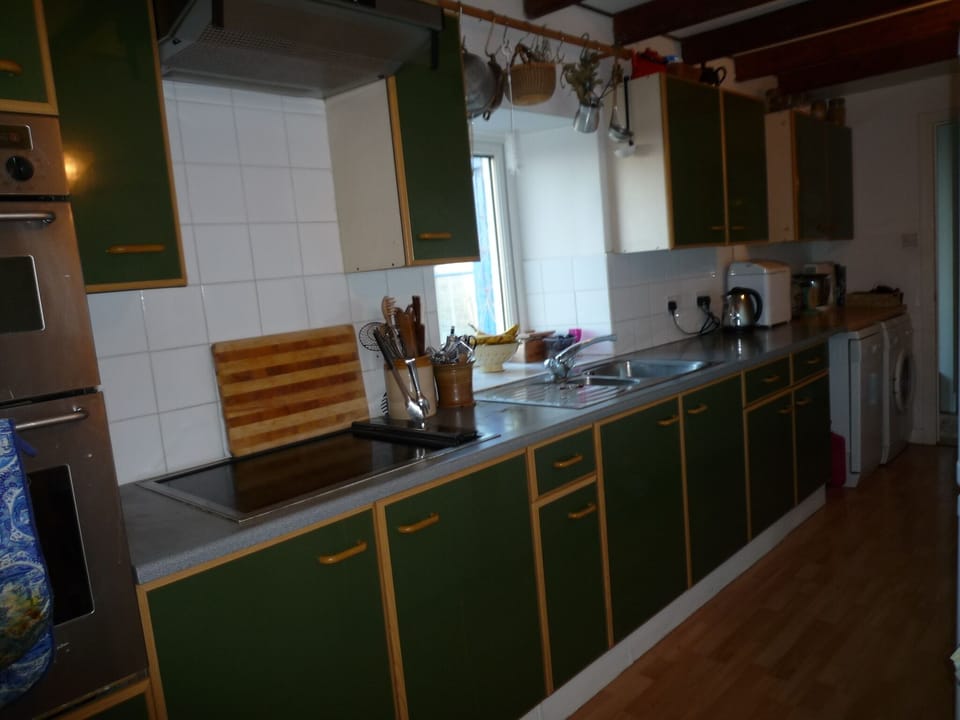 Galley kitchen with oven, hob, microwave, kettle, dishwasher, washing machine, 