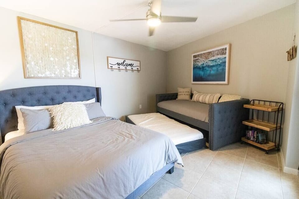 Guest bedroom has a flat screen tv mounted on the wall with cable