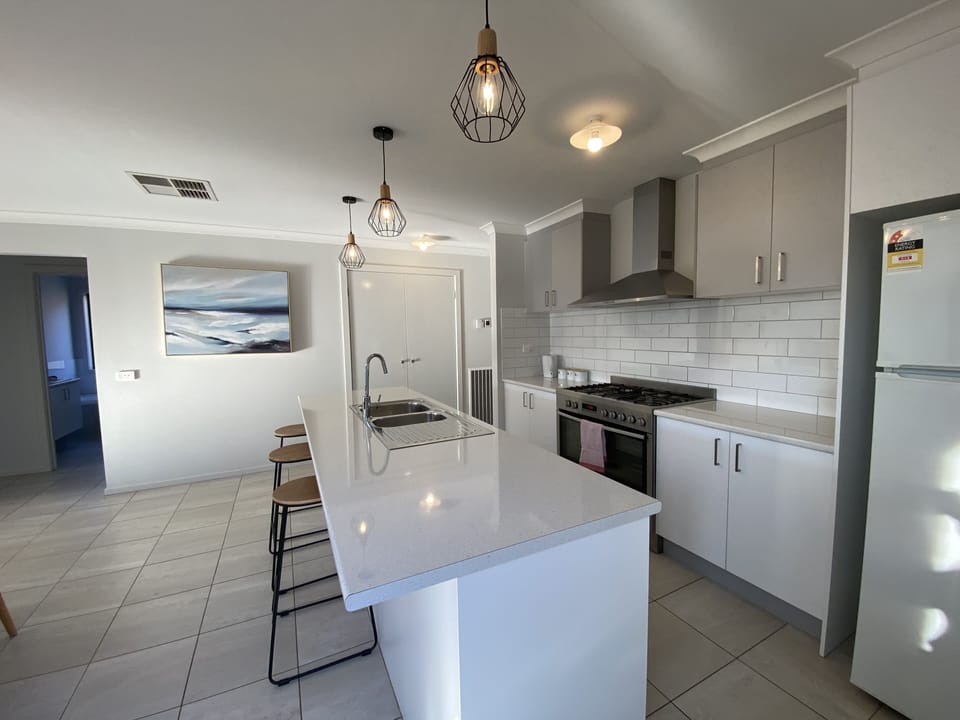 Modern kitchen with 900mm gas oven fridge, dishwasher and microwave 