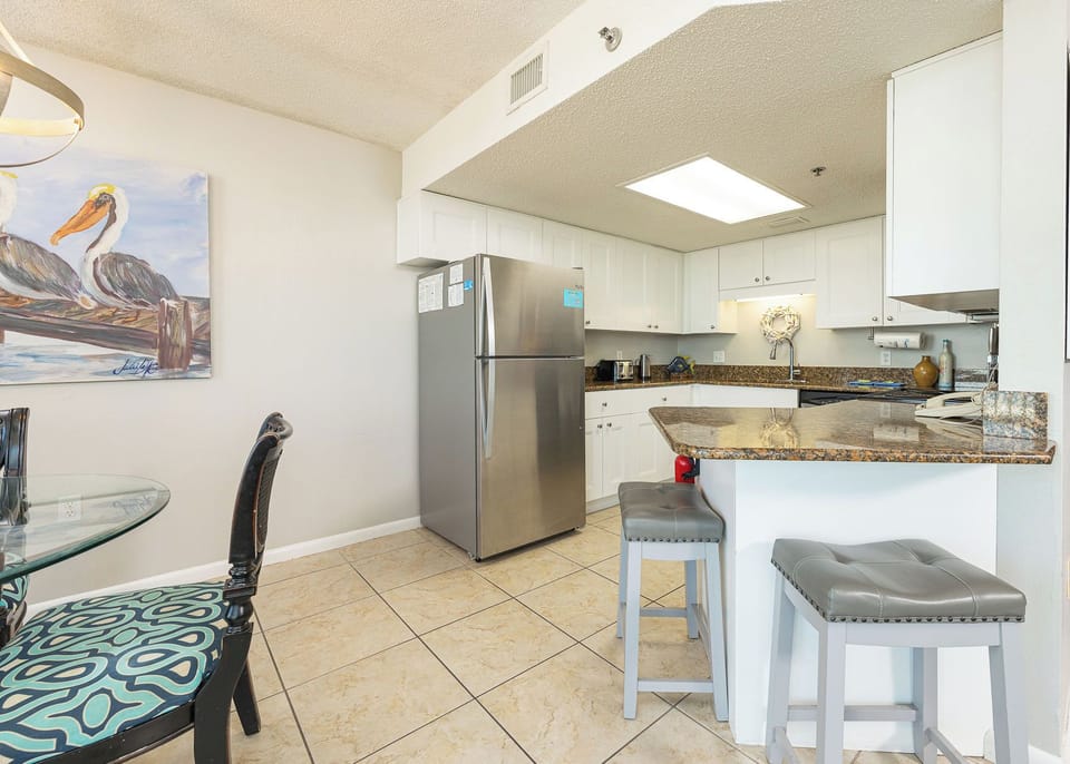 Savor family moments in the kitchen and dining area surrounded by beach decor and a cozy coastal vibe