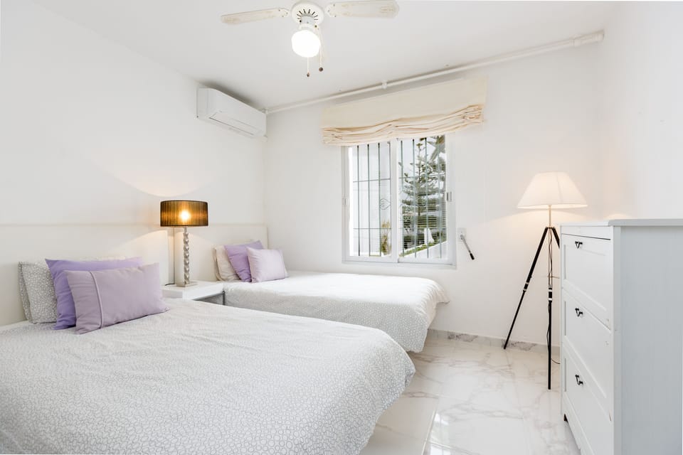 Large and bright bedroom with two twin beds