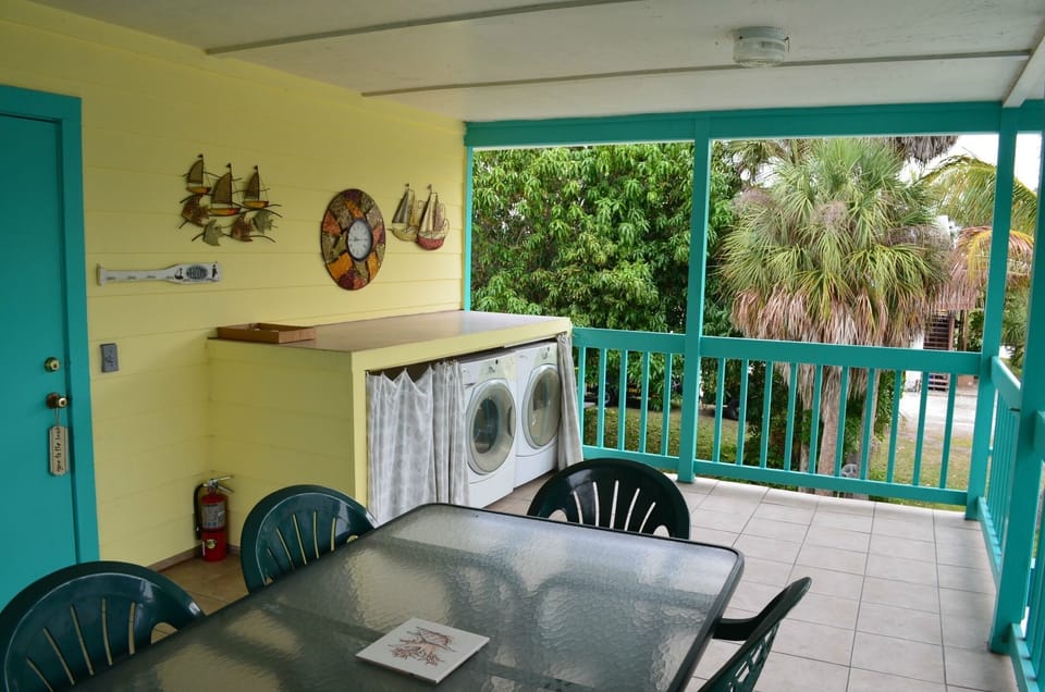 Porch with washer and dryer outside.