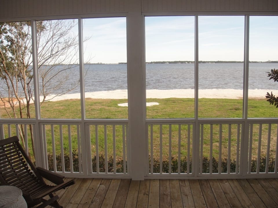 Back screened in porch faces Perdido Bay