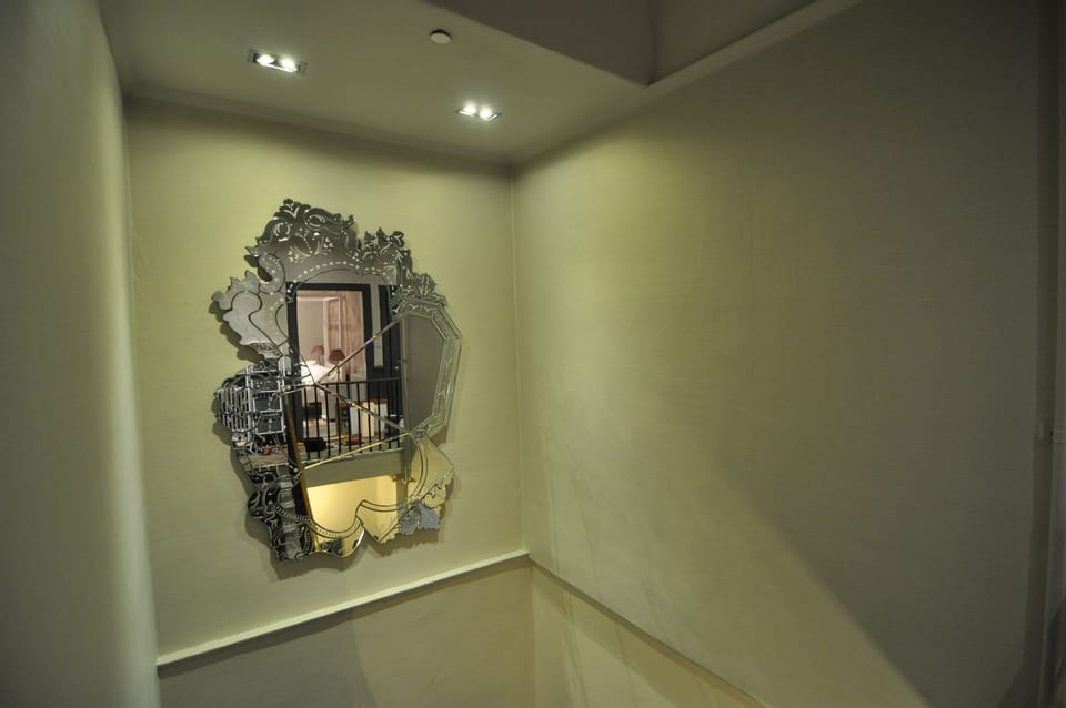 stairwell with large venetian mirror