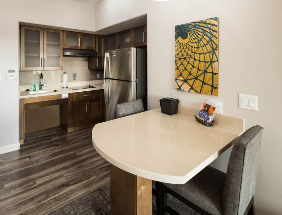 Modern kitchen with stainless steel appliances and a breakfast bar.
