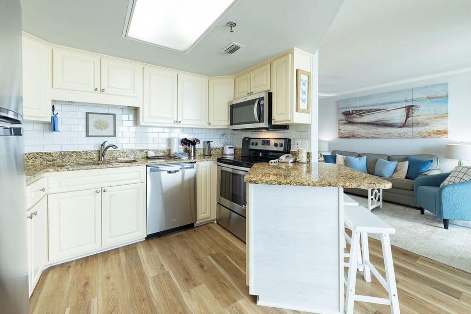 Granite counters in the kitchen invite you to prepare fresh meals while the living room's soft seating welcomes you to unwind