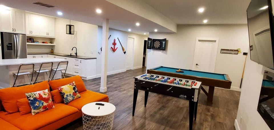 Lower level complete with pool table, foosball table and dart board games