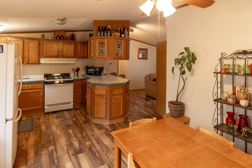 Fully furnished kitchen with microwave and gas stove.