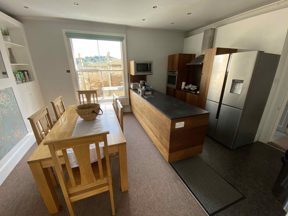 Kitchen with American fridge freezer, washing machine, oven and micro-wave