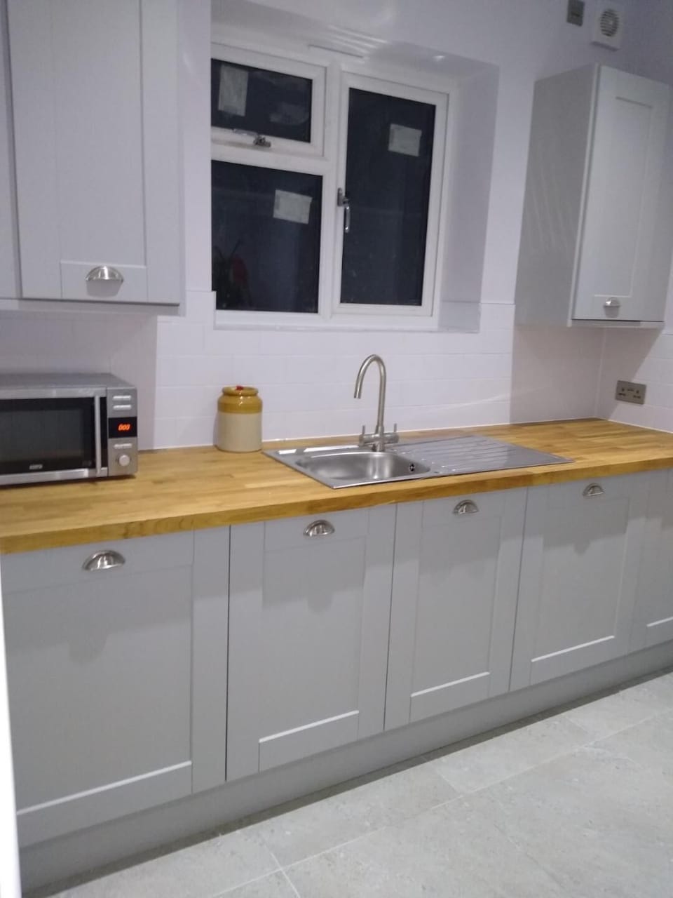 Utility room off the kitchen with washing machine and tumble dryer.