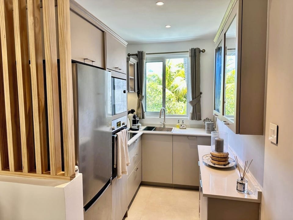 Kitchen including dishwasher, microwave, oven, fridge/freezer, induction hob.