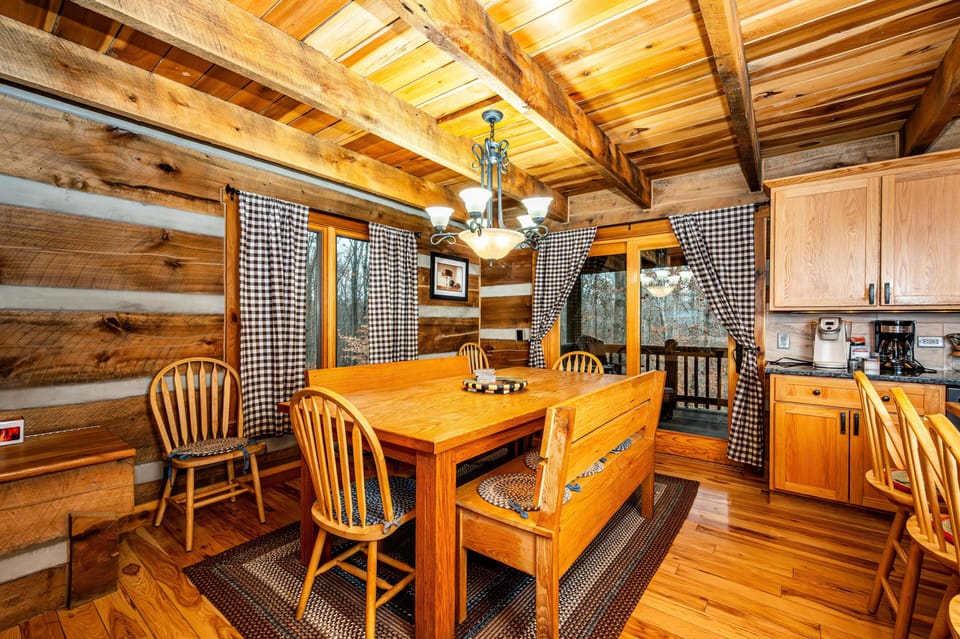 Cozy rustic dining area with warm log cabin charm, perfect for gathering and shared meals.