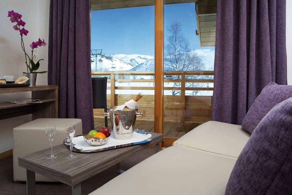 Relax on the comfortable sofa after a wonderful day outside - Please note that views may vary and some units may not have a balcony.