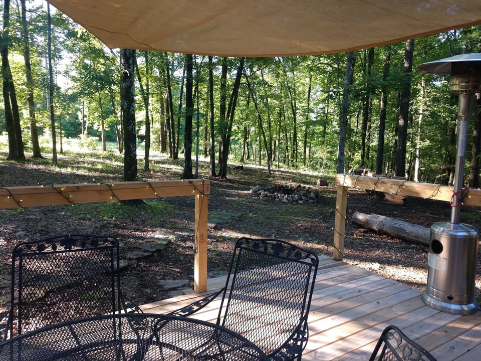 View of firepit and woods from the back deck