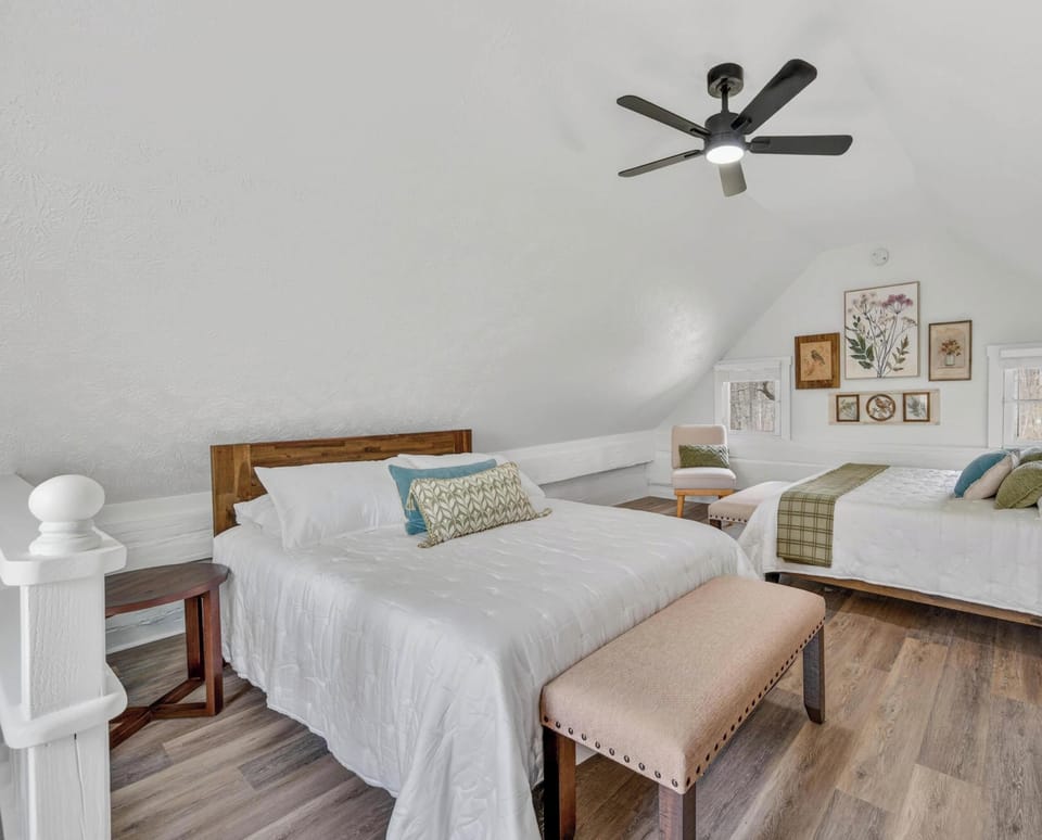 Cozy attic bedroom with vaulted ceilings and rustic charm