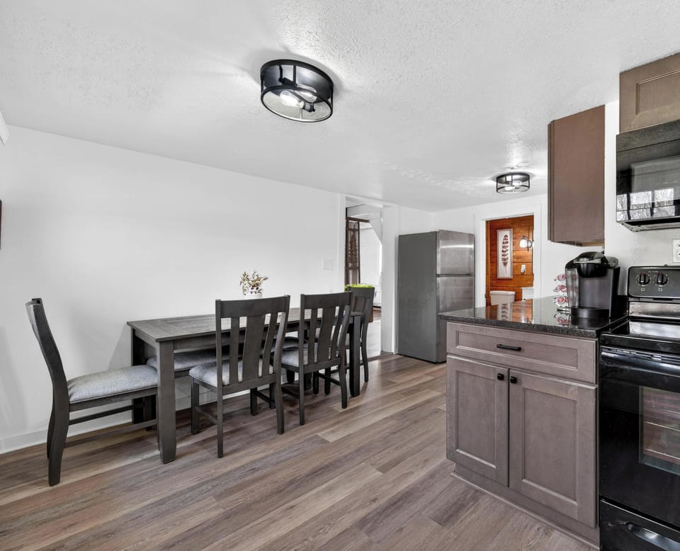 Modern kitchen and dining area with sleek appliances and spacious layout