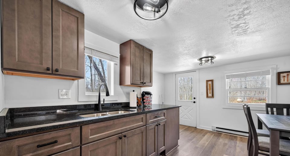 Spacious kitchen with modern cabinetry and open dining area