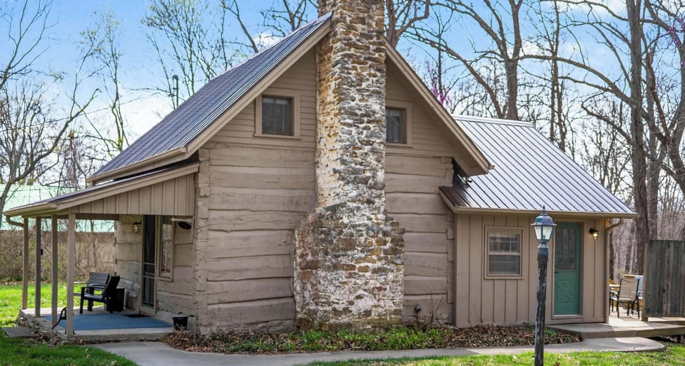Cozy cabin retreat with rustic stone fireplace and porch