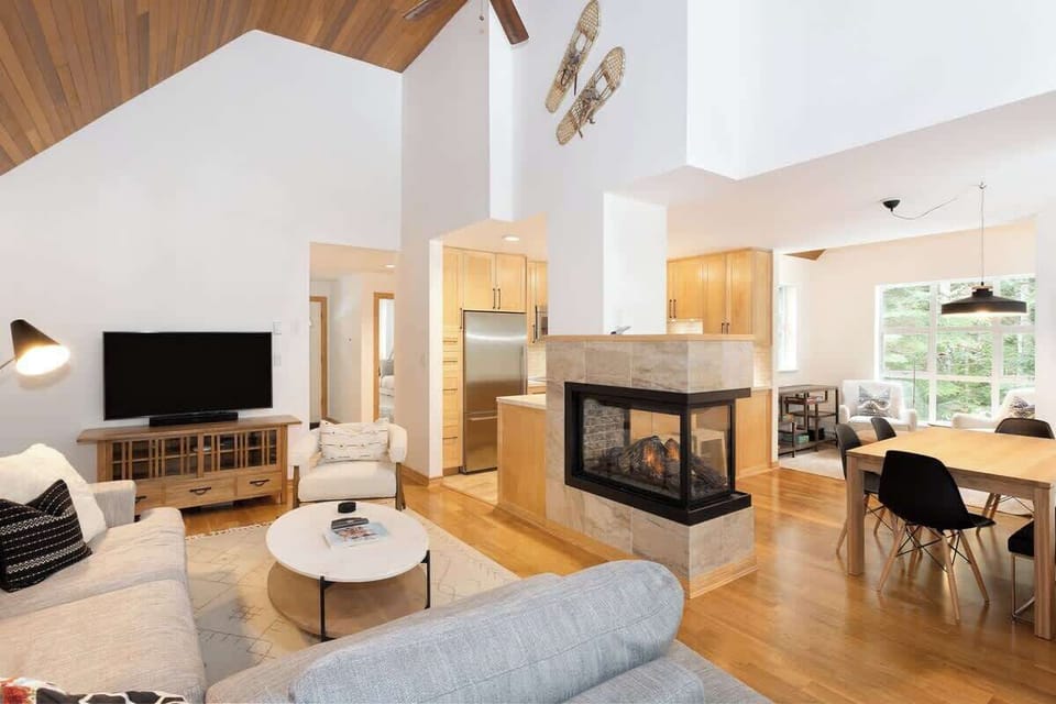 - Spacious open-concept Whistler mountain home interior  
- Designer living room with cozy fireplace and natural light  
- Perfect getaway near slopes, trails, and village dining  
