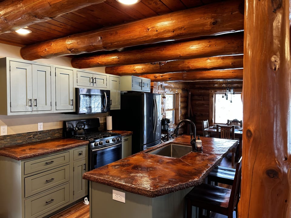 open kitchen with black stainless steel appliances