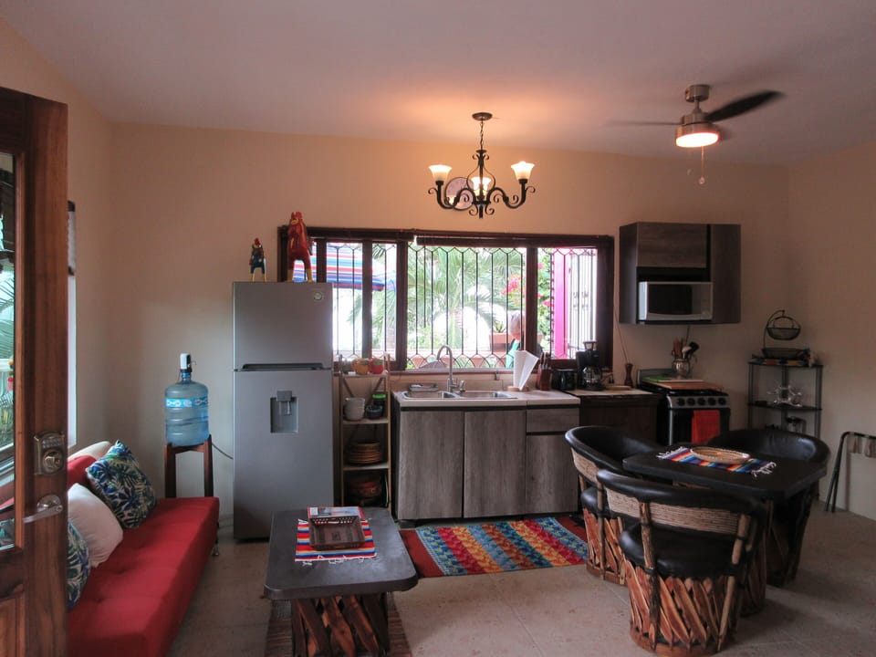 View of ocean from kitchen, table & chairs and from bed.