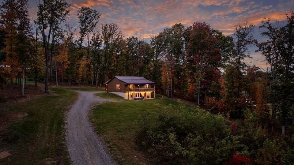 Cozy mountain cabin with glowing skies, a peaceful setting, and rustic-modern comforts