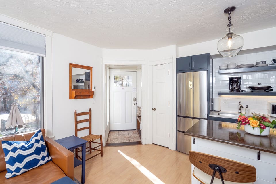 Enter this adorable space, there's a coat rack/bench on your left and into open space featuring the living area and kitchenette.
