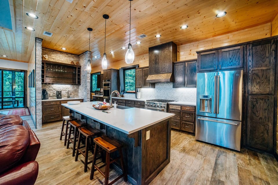 Fully equipped kitchen with quartz counters and stainless appliances.