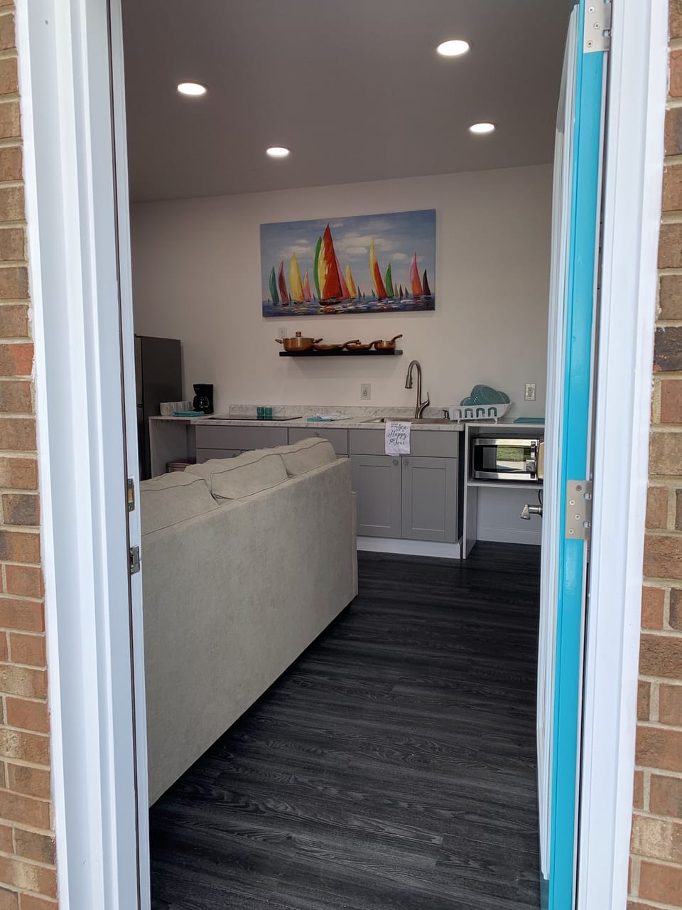 View walking into studio apartment ( living room/ kitchen combo 