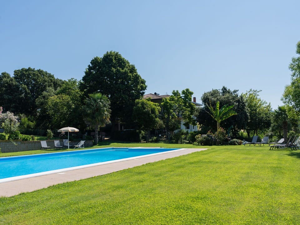 Sky, Plant, Swimming Pool, Tree, Shade, Water, Rectangle, Building, Land Lot, Natural Landscape