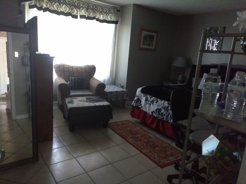 private room with ottoman bay window water stand