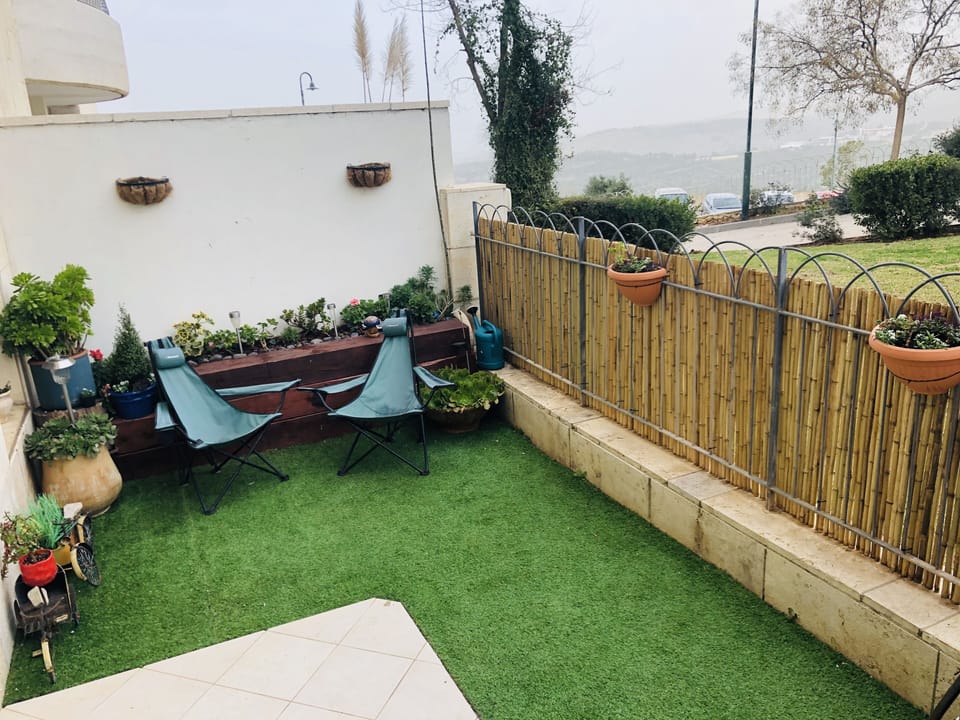 Private garden with green vegetation and views of the Jerusalem mountains