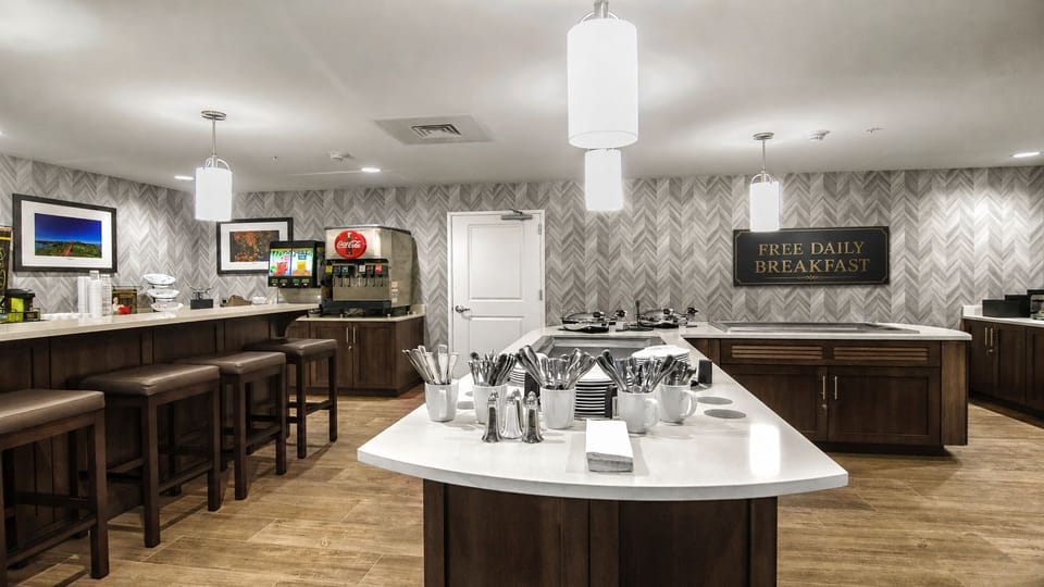 Complimentary breakfast area with buffet stations and dining seating.