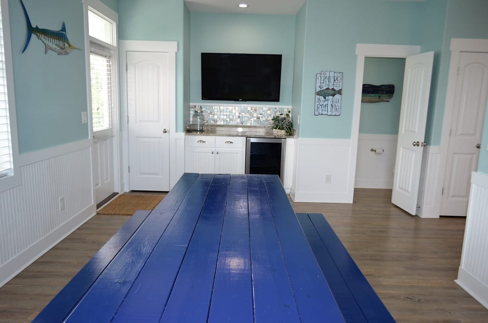 Wine/beverage cooler & large wall mounted flat screen TV.