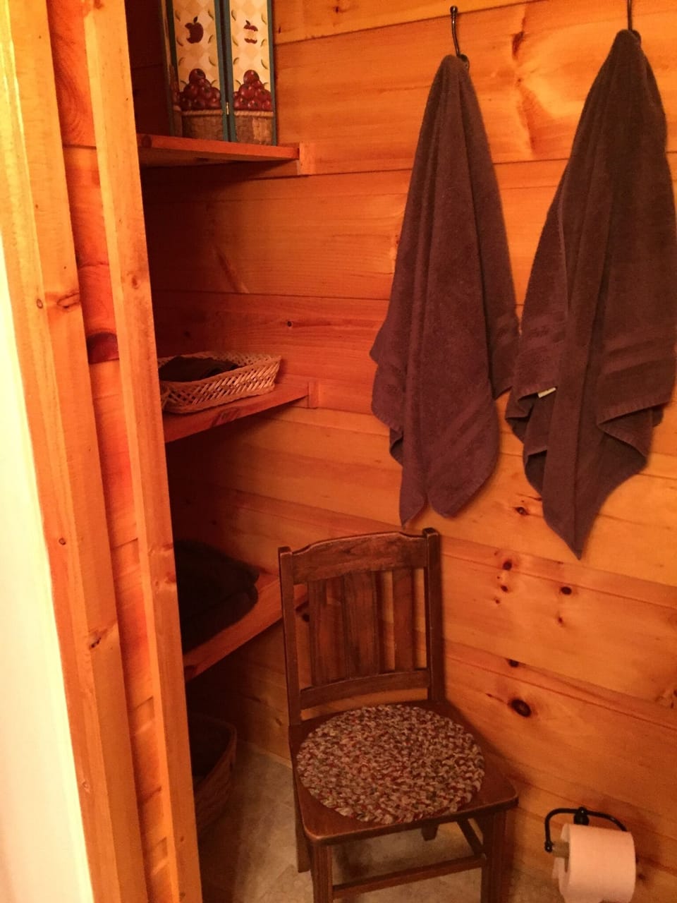 Storage in the master bath featuring a couples shower and mountain charm