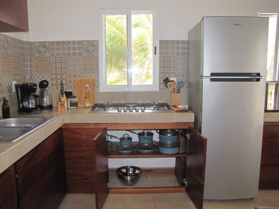 Gas stove, pots and pans, fridge