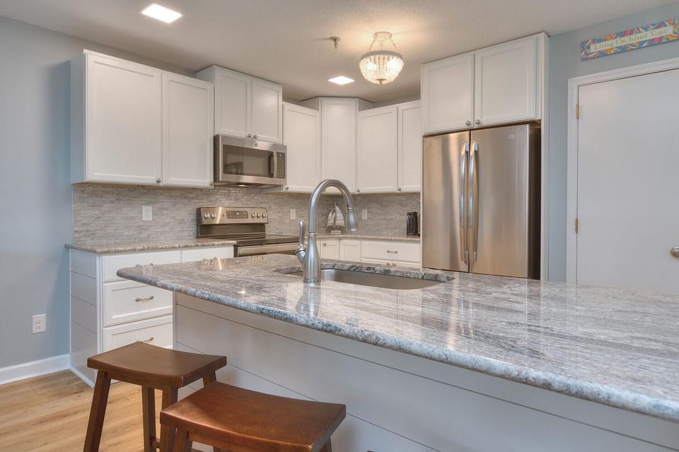 Beautiful updated kitchen with new cabinets, granite countertops, backsplash...