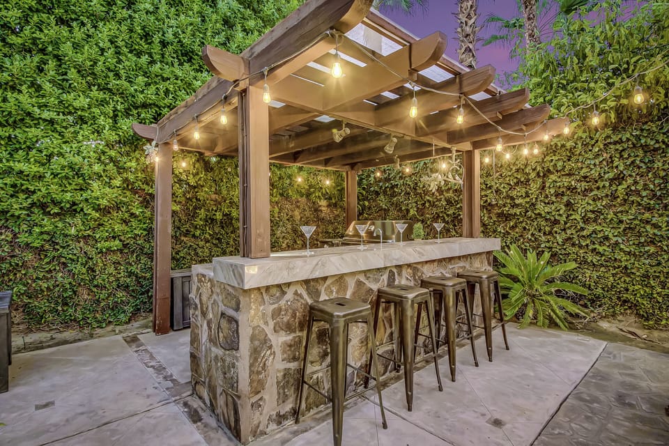 The lounge area is conveniently located next to the covered barbecue and bar area, which features 4 bar stools.