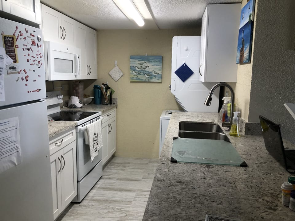 Kitchen with dishwasher and microwave with stackable washer and dryer....