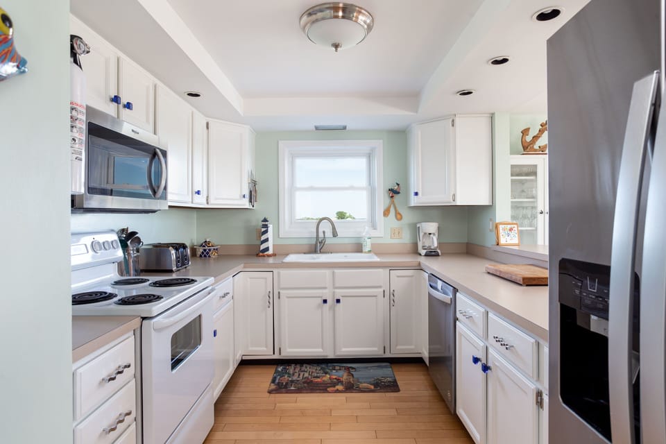 Main kitchen on second floor open to living/ dining area and ocean views