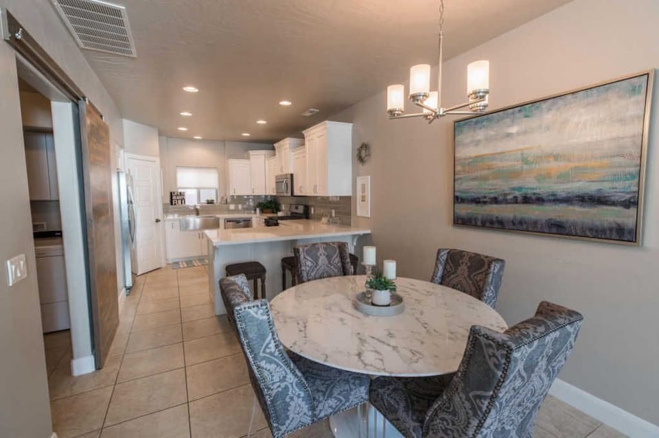 Dining area, marble table with 4 seats, and 3 chairs @ the quartz countertop bar