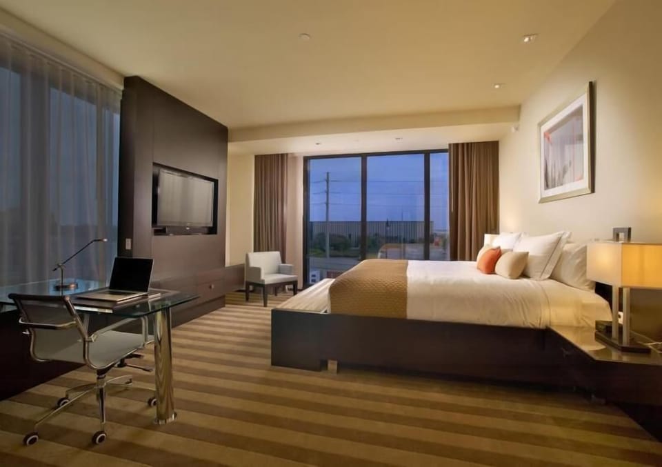 Settle into a spacious room with calming evening glow.
