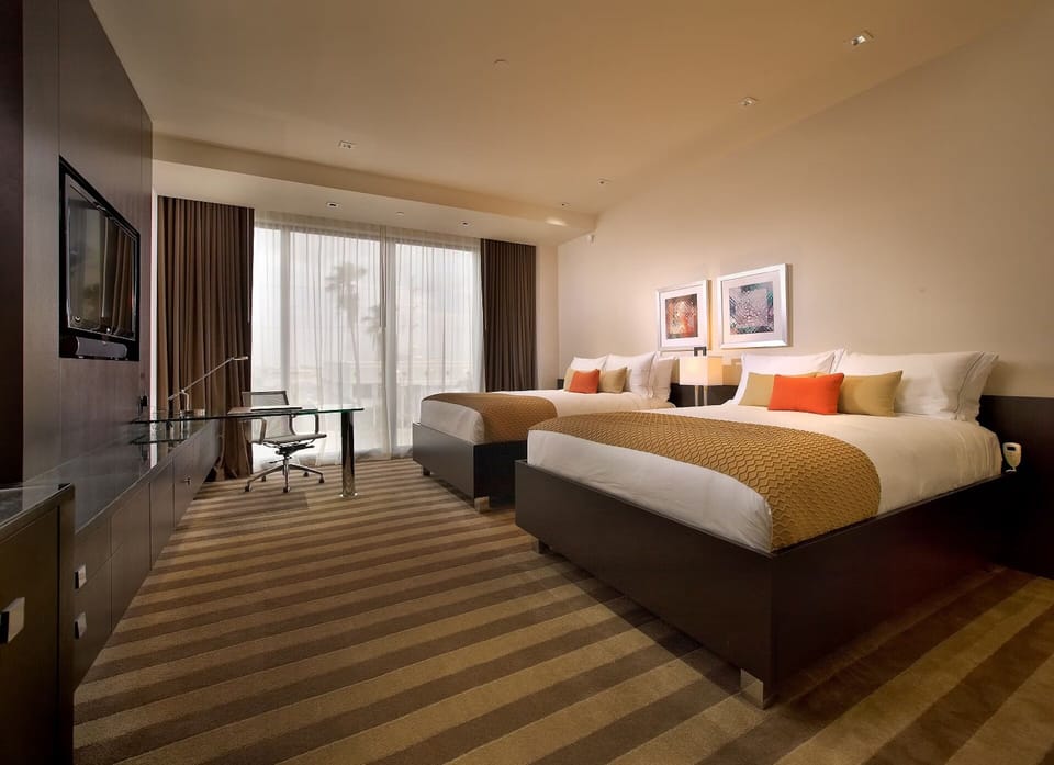 Wake up to soft daylight streaming across pristine bedding.