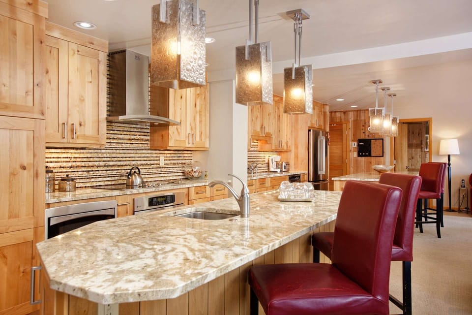 Beautiful tile work, granite countertops, stainless steel appliances and fine wood are featured in the remodeled kitchen.