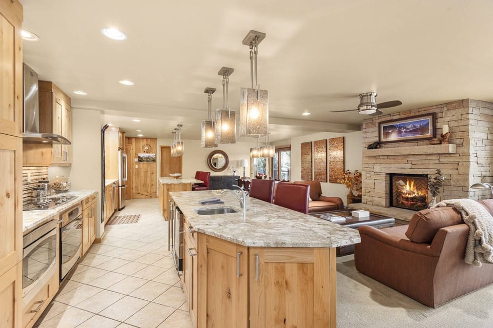 The chef will love cooking and being able to enjoy the fire, view and company in this open-concept kitchen and living space.