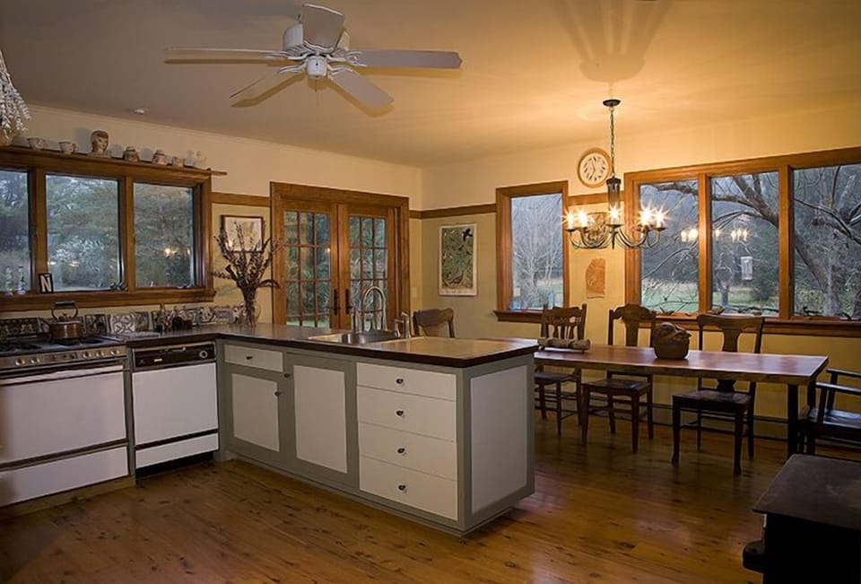 Spacious and airy fully-equipped modern kitchen with a large dining table.