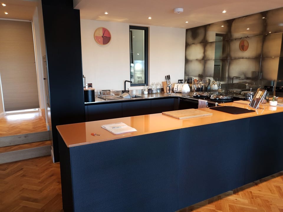 Kitchen area with Aga and glass worktop