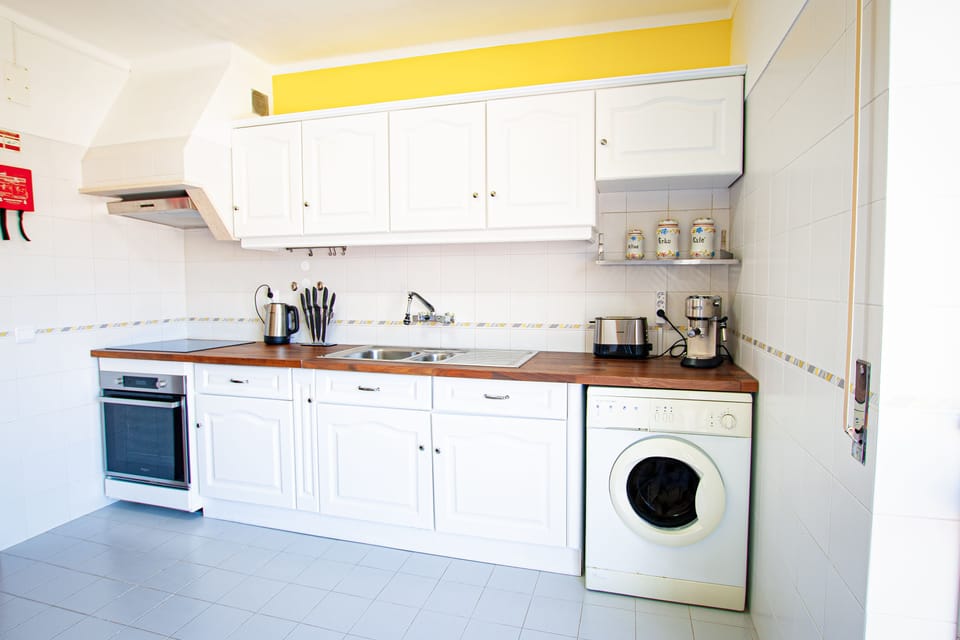 Full kitchen with barista coffee machine, kettle, toaster + fridge and microwave