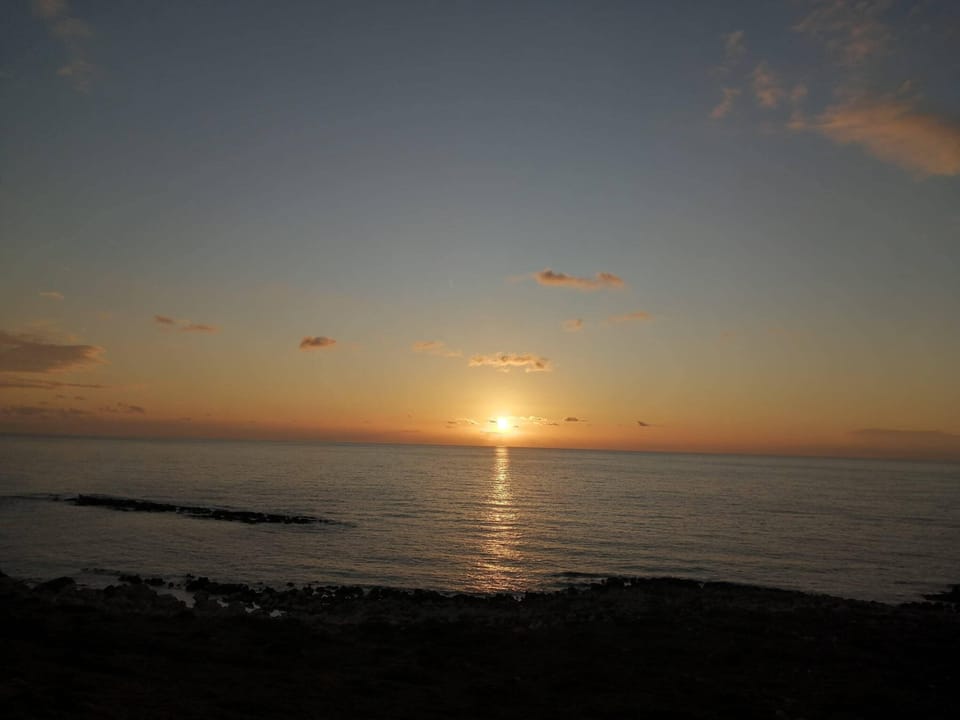 Sunset View from the Property Balcony – Magical evening scenery over Ammoudi Bay.